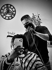 a man is getting his hair cut by a barber