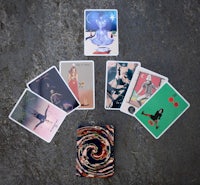 tarot cards on a table with a picture of a woman