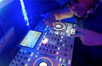 a dj in a room with a dj mixer