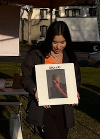a woman holding up a picture of a person