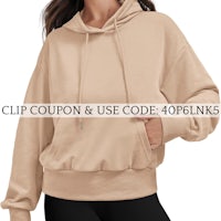 a woman wearing a beige hoodie with the words clip coup and use