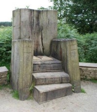 a wooden throne in a wooded area