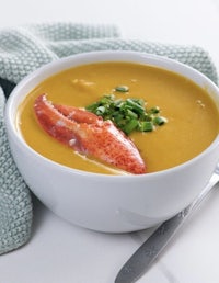 a bowl of soup with lobster in it