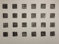 a group of black and white photographs on a wall