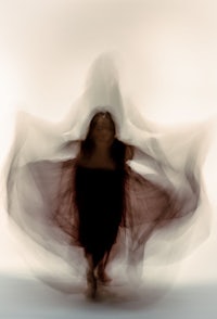 a blurry image of a woman in a dress