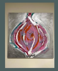 an abstract painting of an onion hanging on a wall