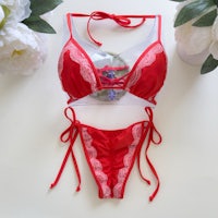 a red bikini set with lace and flowers