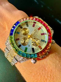a person's wrist with a colorful watch on it