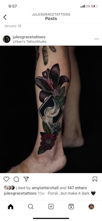a tattoo of a woman's leg with flowers on it