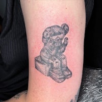 a tattoo of a koala sitting on a box
