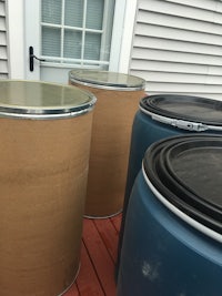 three barrels sitting on a wooden deck