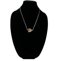 a necklace with a heart shaped pendant on a mannequin