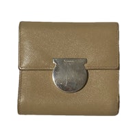 a beige leather wallet with a metal clasp