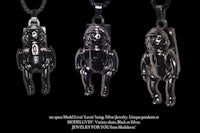 three black necklaces with a black astronaut on them