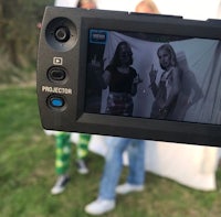 a camera is being used to take a picture of two people
