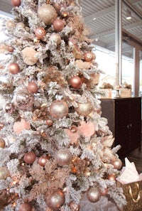 a christmas tree decorated with pink and gold ornaments