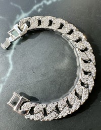 a silver bracelet with diamonds on it