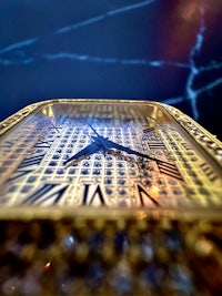 a close up of a gold clock