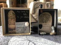 two small boxes with a gravestone on them