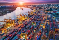 an aerial view of a container port at sunset