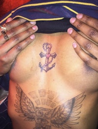 a person with an anchor tattoo on their back