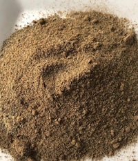 a bowl of brown powder on a white plate