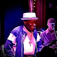 a man wearing a hat and a hat on stage