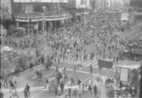 a black and white photo of a crowded city street