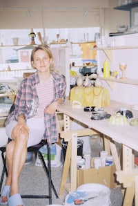 a woman sitting on a chair in a studio