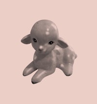 a small figurine of a lamb on a pink background