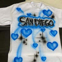a white t - shirt with blue hearts and san diego written on it