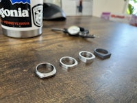a set of rings on a table next to a mug