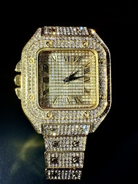 a gold watch with diamonds on it