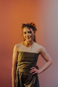 a woman in a strapless dress posing for a photo
