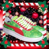 a pair of green and white puma sneakers with christmas decorations