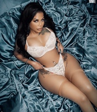 a woman in lingerie laying on a bed