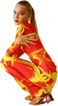 a woman crouching down in a red and yellow jumpsuit