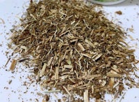 a pile of dried herbs on a white plate
