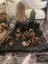 a collection of copper jewelry on a table