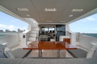 the interior of a luxury yacht with a dining table and couches