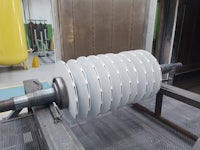 a white roller is being made in a factory