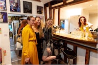 a group of women posing for a photo at a bar