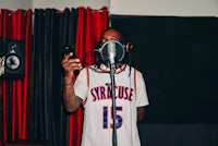 a man holding a microphone in a recording studio