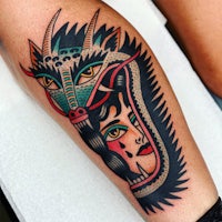 a tattoo of a woman with a dragon on her leg