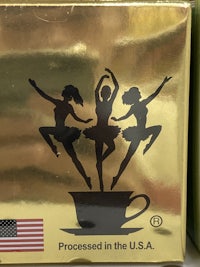 a gold box with two dancers on it
