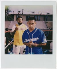 two men standing next to each other in polaroid