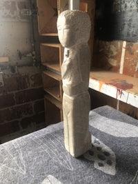 a sculpture is sitting on a table in a workshop