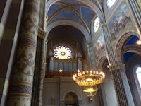 the inside of a cathedral with ornate ceilings and chandeliers
