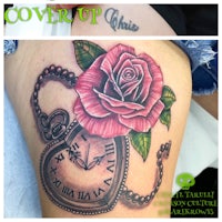 a tattoo with a clock and a rose