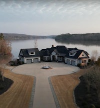 an aerial view of a lakefront home